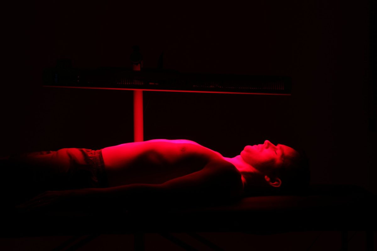 A man lying below LumiPro Panel adjusted using LumiPro Horizontal stand